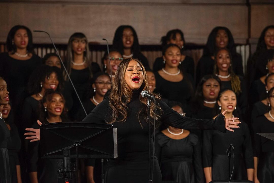 Gospel singer Erica Campbell and The Spelman College Glee Club performing together at the 97th Annual Spelman-Morehouse Christmas Carol Concert.